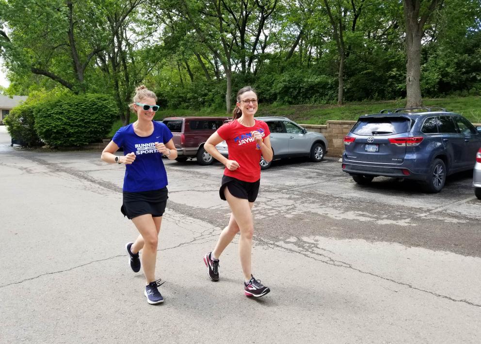 Two female employees jogging together after work.