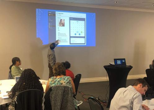 Graphic Designer Sean Blake presenting application designs for a client management and communication tool at a DCF workshop in 2019. 